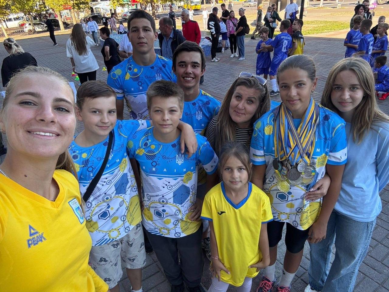 Coach and athletes with medals